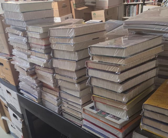 Shrink-wrapped stacks of hardcover books in our warehouse